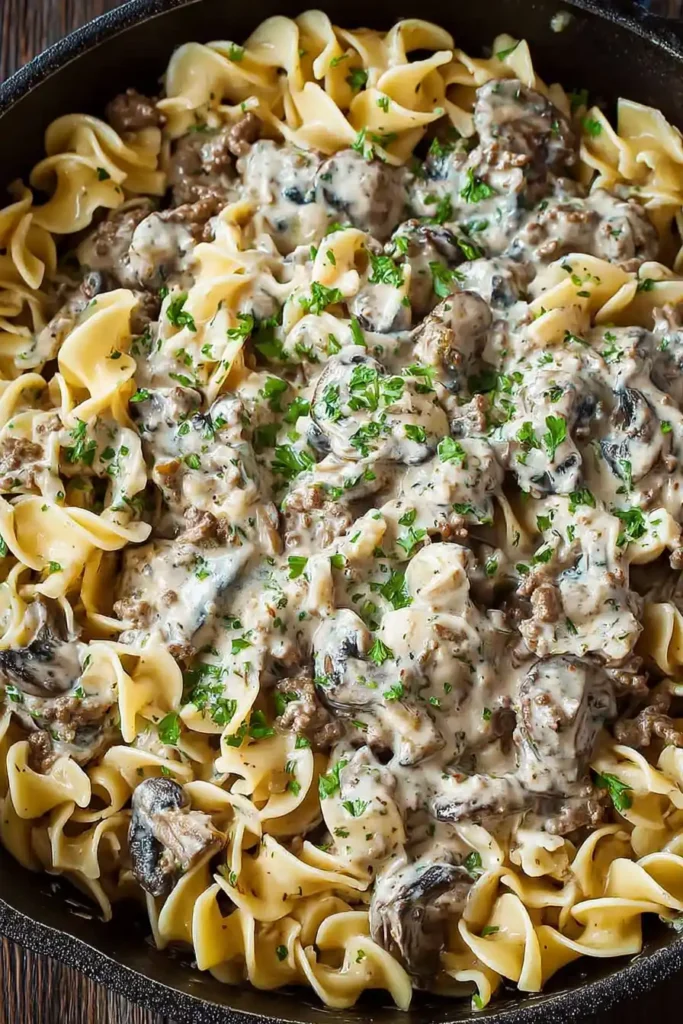 Skillet of creamy beef stroganoff with ground beef and egg noodles ready to serve