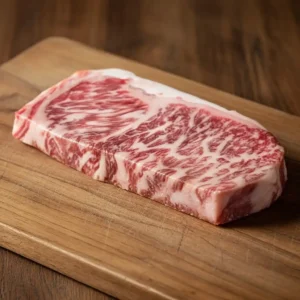 Raw marbled Kobe beef steak on wooden cutting board – Wagyu vs Kobe beef cut