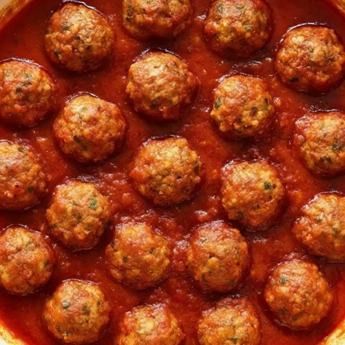 Pan of Kobe beef meatballs simmering in tomato sauce