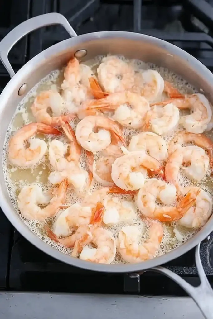 Shrimp cooking in garlic butter sauce for creamy shrimp scampi pasta