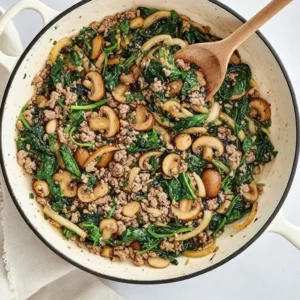 Ground beef and spinach simmering with mushrooms in one pot