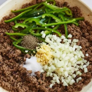 Browned ground beef with onions cooking in skillet for Philly Cheesesteaks