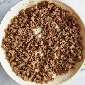 Browned ground beef cooking in skillet for Philly Cheesesteaks