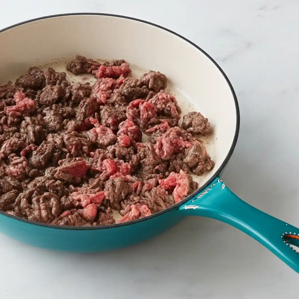 Ground beef browning in skillet for Cheesy Ranch Ground Beef and Rice Casserole