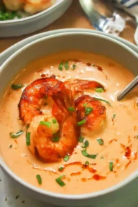 Creamy shrimp bisque topped with sautéed shrimp and drizzled oil