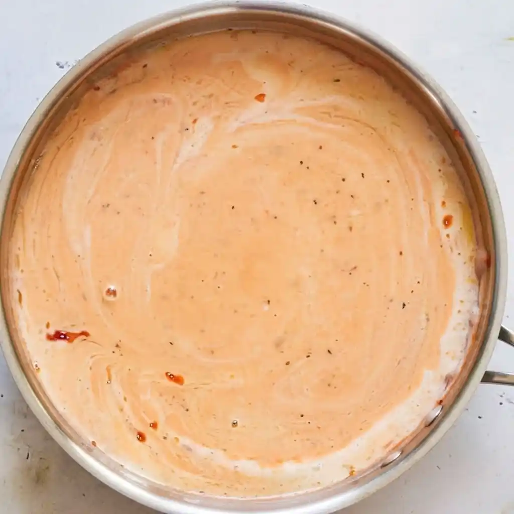 Creamy bisque base simmering in saucepan