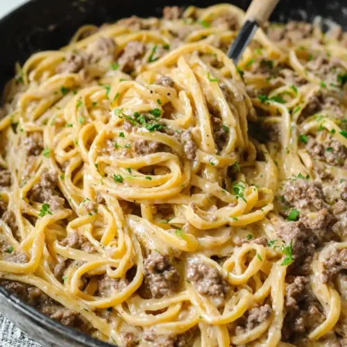 creamy one-pot garlic butter beef pasta in skillet topped with parsley
