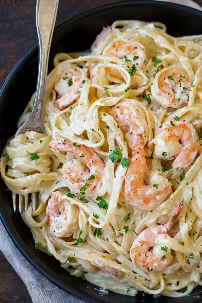 A close-up of creamy shrimp scampi pasta made with angel hair pasta, garlic butter, and lemon-infused cream sauce — a comforting, restaurant-style family dinner.