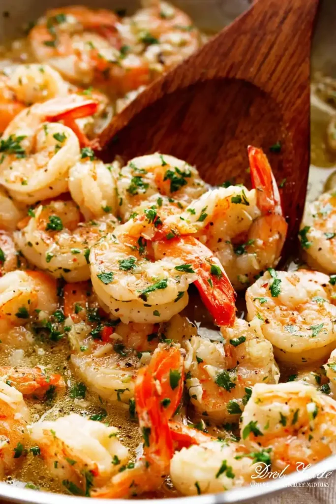 Garlic butter shrimp scampi served with linguine and parsley garnish