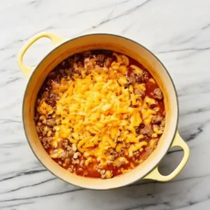 Melting shredded cheddar into hamburger helper