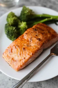 maple bourbon salmon on plate with vegetables