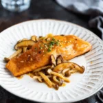 miso butter salmon plated with shiitake and shimeji mushrooms