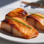 Miso salmon recipe Nobu: Miso salmon Nobu style served on white plate with garnish