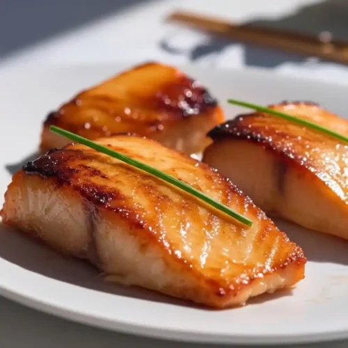 Miso salmon recipe Nobu: Miso salmon Nobu style served on white plate with garnish
