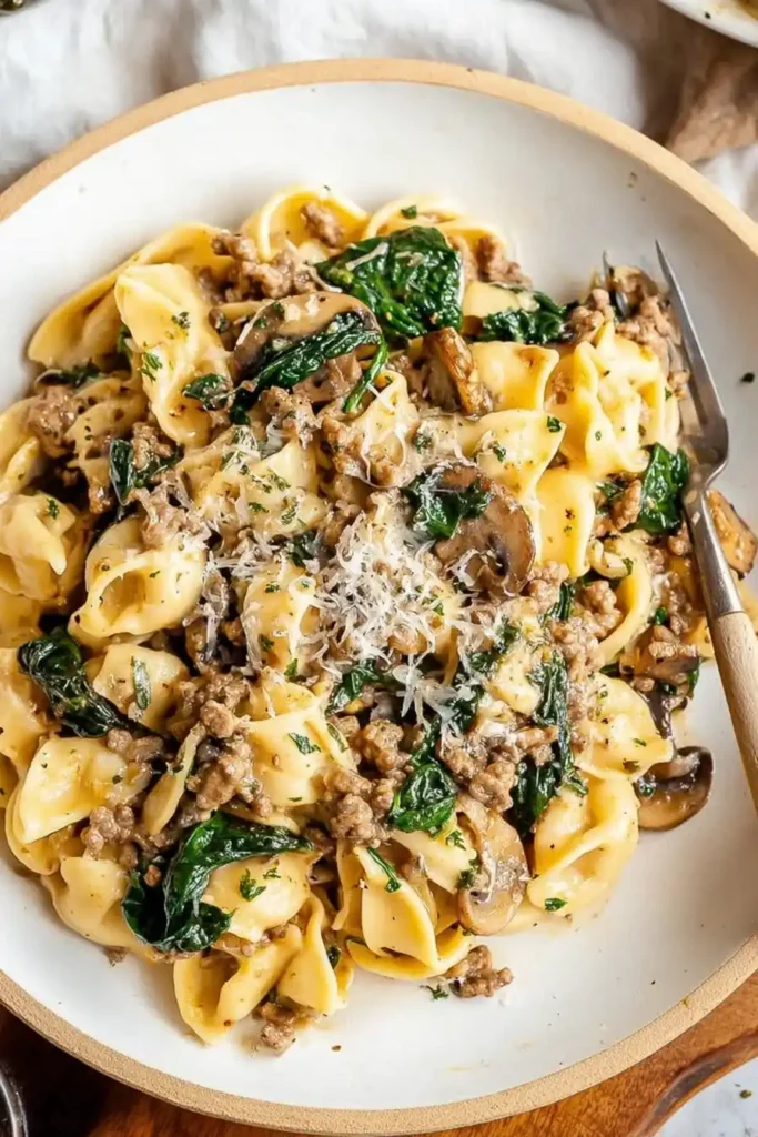 One Pot Cheesy Mushroom Spinach Beef Pasta in a creamy sauce with mushrooms and spinach