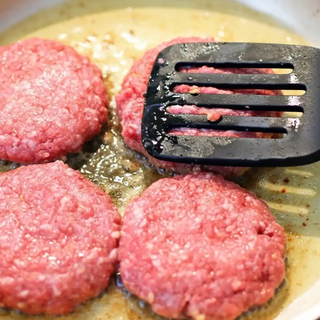 Cooking Salisbury steak patties in skillet until browned