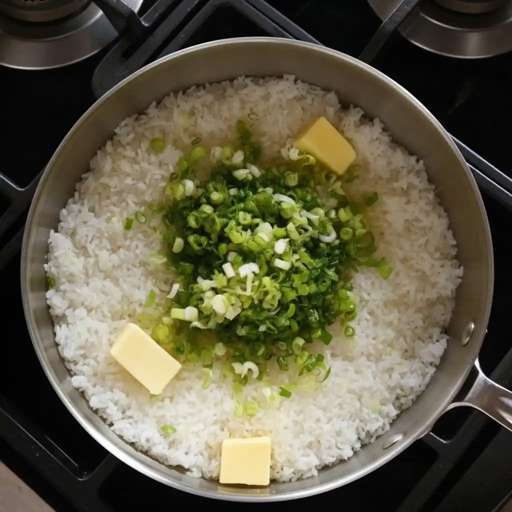 Mixing scallions and butter into rice for Sticky Miso Salmon Bowl