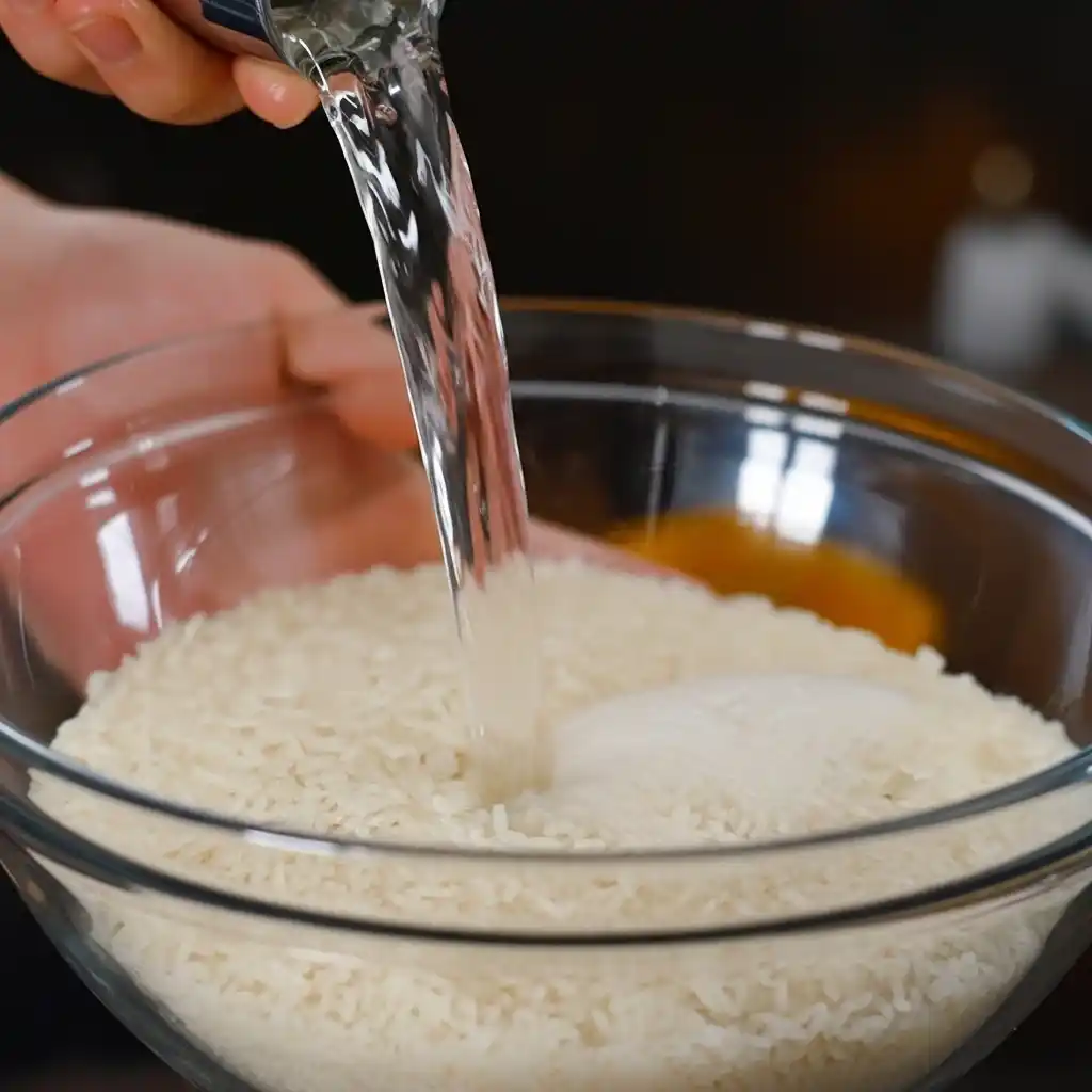 Rinsing sushi rice for Sticky Miso Salmon Bowl
