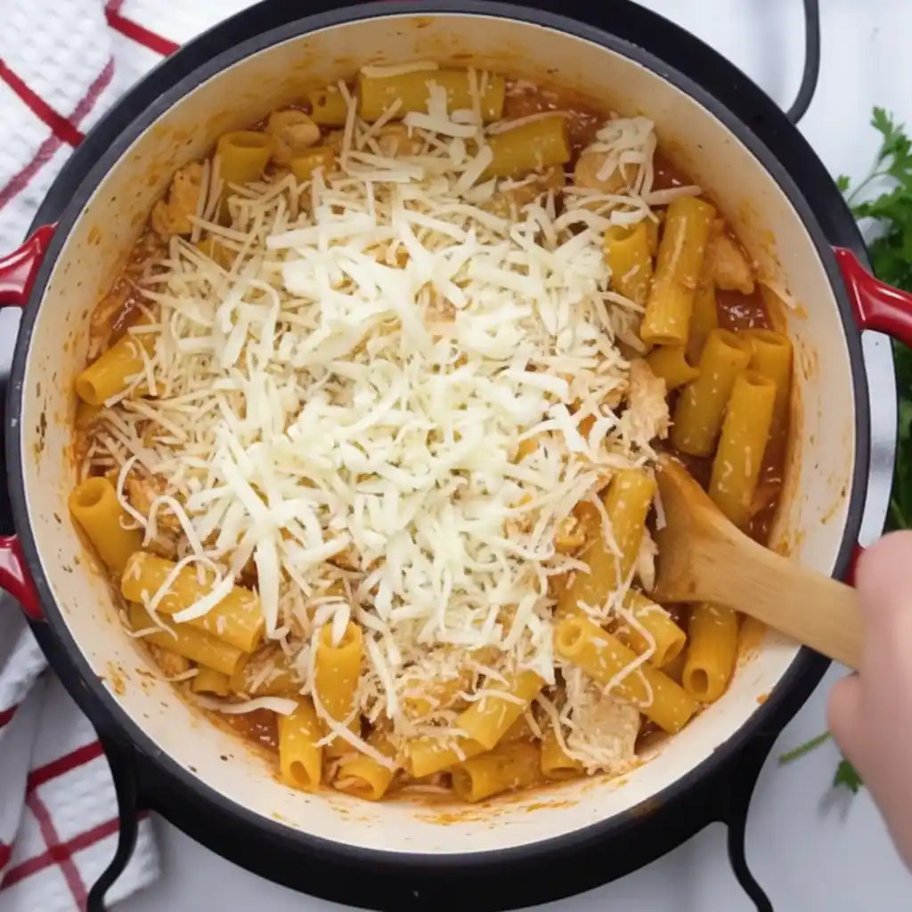 Adding mozzarella and parmesan to easy chicken parmesan pasta