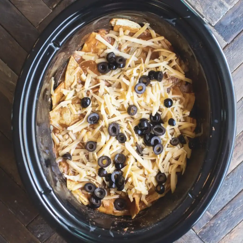 Chicken Enchilada Crockpot Casserole layered with cheese and olives