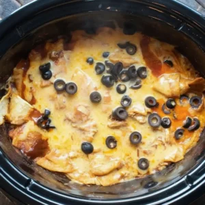 Chicken Enchilada Crockpot Casserole fully cooked with melted cheese and olives