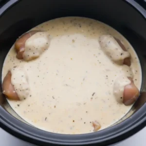 creamy garlic parmesan chicken pasta cooking in crock pot