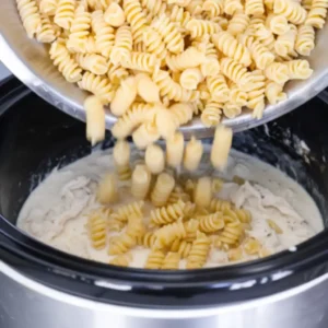 adding pasta to crock pot garlic parmesan chicken