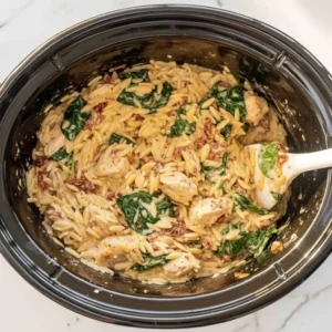 Creamy Tuscan chicken orzo with spinach and Parmesan in slow cooker