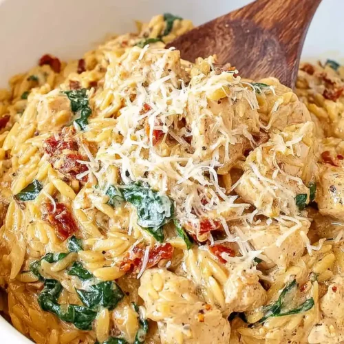 Creamy Tuscan chicken orzo with spinach and Parmesan in slow cooker