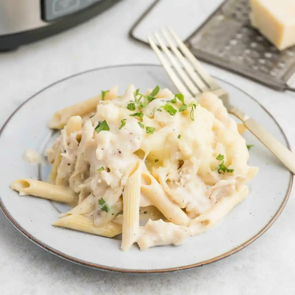 creamy crockpot chicken alfredo bake served on plate