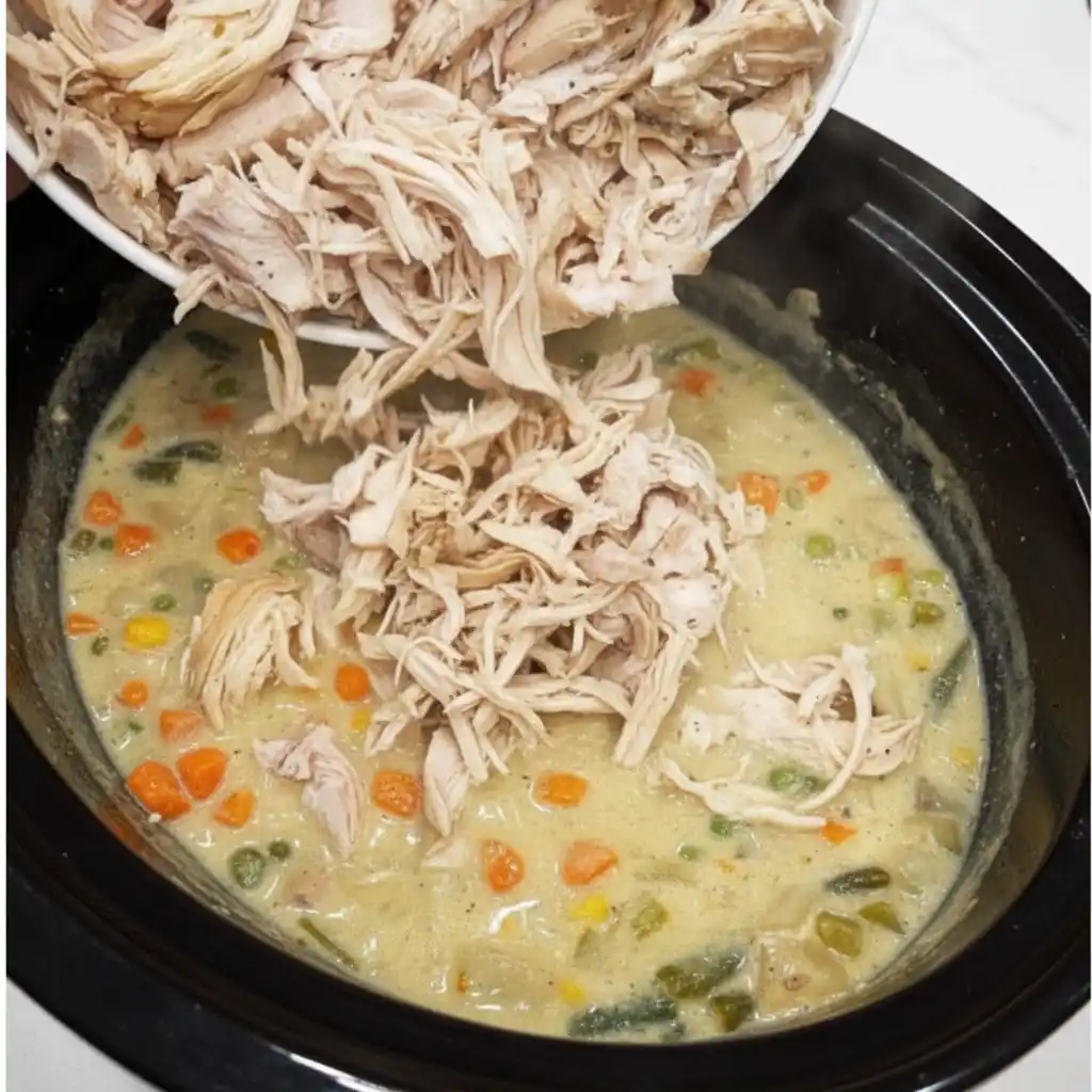 Crockpot filled with creamy chicken pot pie mixture