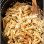 Slow Cooker Cajun Chicken Pasta in creamy sauce inside a crockpot