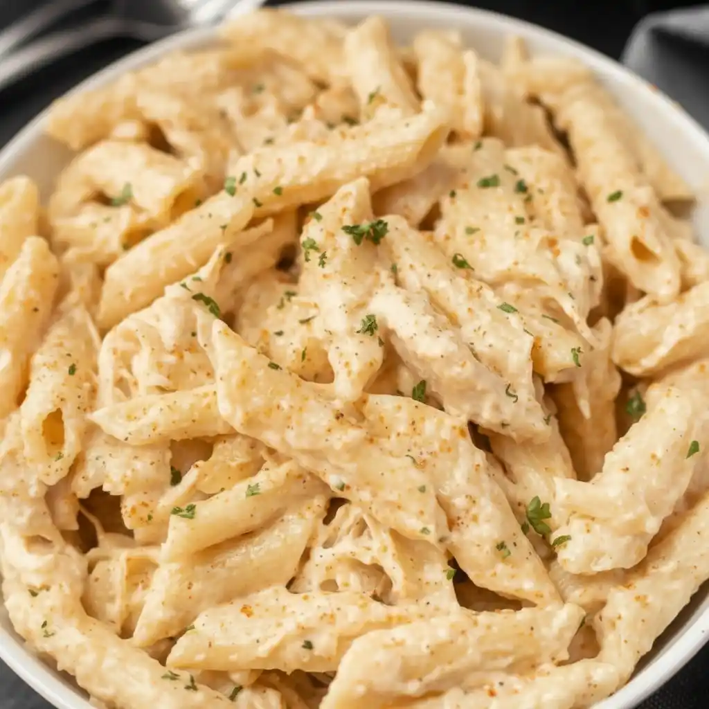 Bowl of creamy slow cooker Cajun chicken pasta ready to serve