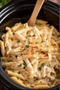 Cooking Cajun chicken pasta in the crockpot with creamy sauce