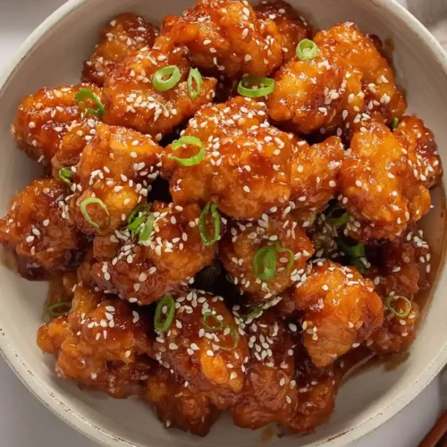 Honey Sesame Chicken in bowl with sesame glaze