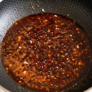 Honey sesame sauce simmering in wok